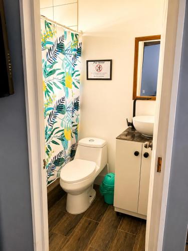 a bathroom with a toilet and a sink at Cabaña bosquepaz in Algarrobo