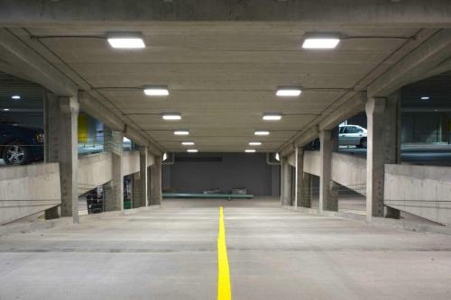 an empty parking garage with cars parked in it at Victoria Royal Garden in Como