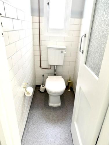 a bathroom with a white toilet and a window at Royal Hotel Tumut in Tumut