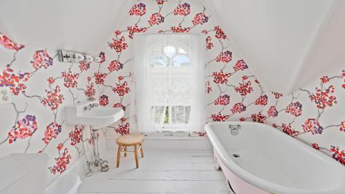 a bathroom with a tub and a sink at Victorian On North in Cape May