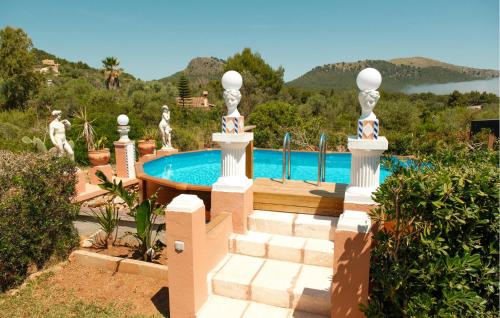 a house with a swimming pool and some stairs at Silencio in Cala Ratjada