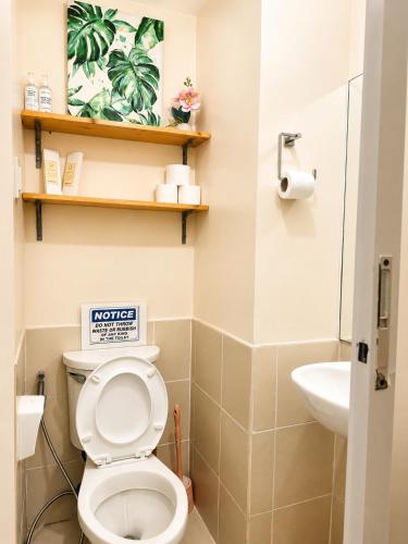 a bathroom with a toilet and a sink at Cityscape Suite in Davao City