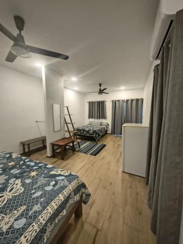 a bedroom with a bed and a ceiling fan at Casa Mango Jardin in San Francisco