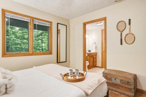 a bedroom with a bed with a bowl of food on it at Up North Chalet Ac Bbq Bikes in Cedar