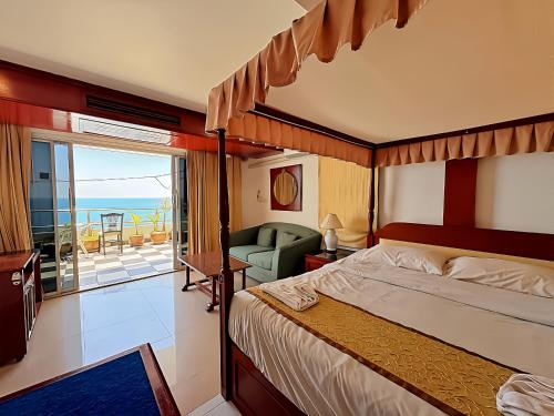 a bedroom with a bed and a view of the ocean at Orchid Hotel and Spa Kalim Bay in Patong Beach