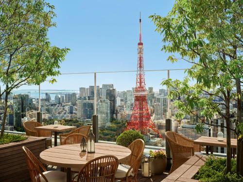 a restaurant with a view of the eiffel tower at The Tokyo EDITION, Toranomon in Tokyo