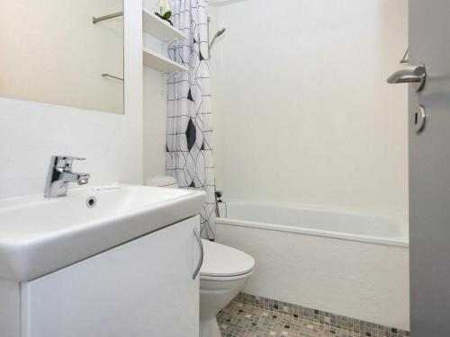 a white bathroom with a sink and a toilet at 6 person holiday home in Glesborg in Glesborg