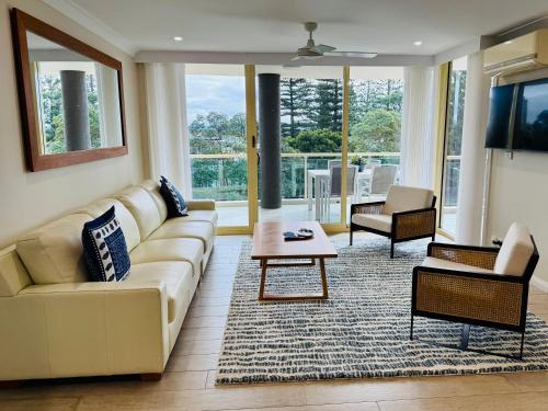 a living room with a couch and a table at Northpoint Apartments in Port Macquarie