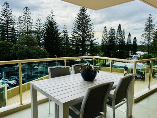 a white table and chairs on a balcony at Northpoint Apartments in Port Macquarie