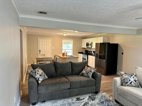 a living room with a couch and a kitchen at Twin Oaks Haven in Murfreesboro