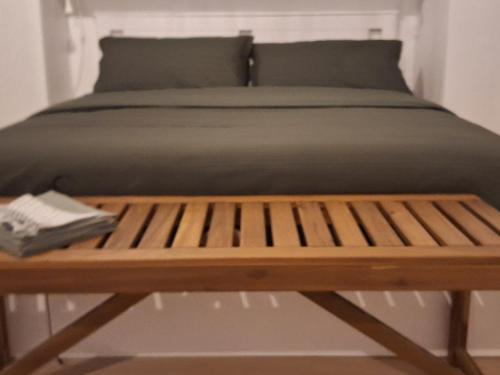 a bed with a wooden bench next to it at Il Giardinetto in Riva di Solto