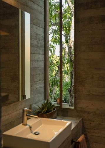 a bathroom with a sink and a mirror and a window at Casa Macu Boutique Homes in La Salada