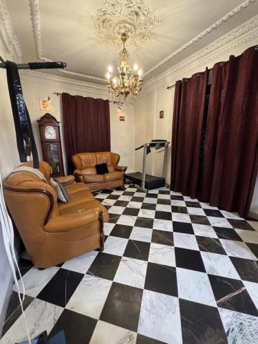 a living room with a black and white checkered floor at Maison moderne & cosy in Constantine