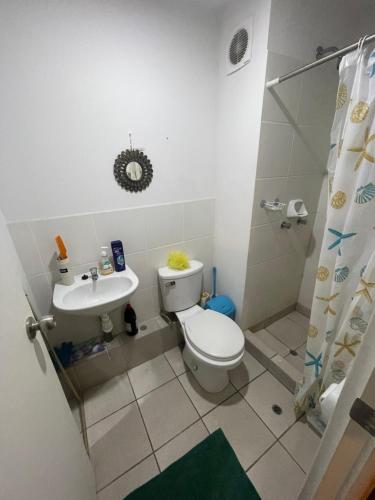 a bathroom with a toilet and a sink at Los Laureles -Executive Residence Departamento in Lima