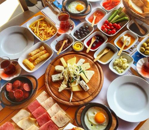 a table with many plates of food on it at My Marin Otel in Turgutreis