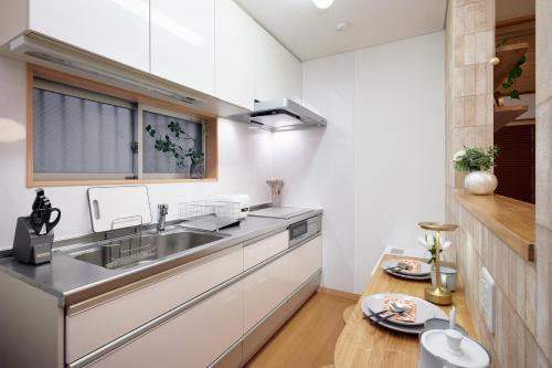 a kitchen with a sink and a counter at R STAY Nagoya Juocho in Nagoya