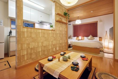a bedroom with a bed and a table in a room at R STAY Nagoya Juocho in Nagoya