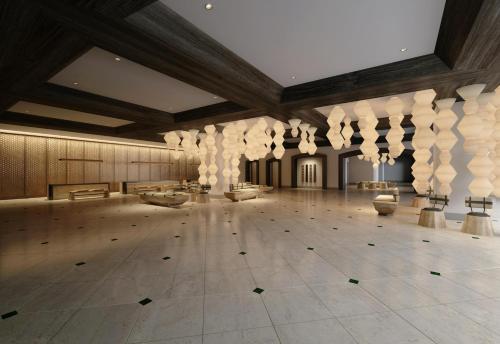 a large room with a large room with columns and tables at Hilton Takayama Resort in Takayama