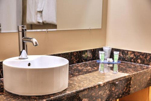 a bathroom counter with a white sink on it at Lone Star Hotel in North Battleford