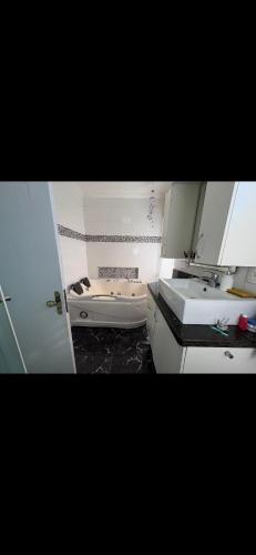 a bathroom with a sink and a toilet at Quarto Suíte Master Luxo in Santana do Livramento