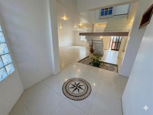a large room with a tile floor in a building at Quarto Suíte Master Luxo in Santana do Livramento