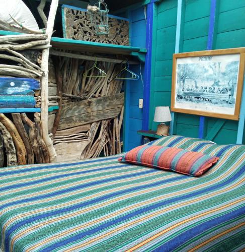 a bedroom with a bed with a blue wall at Kismet Inn Semi Private in Hopkins