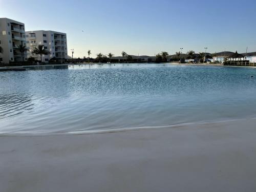 a large body of water with buildings in the background at Mazablue, alberca más grande de México in Mazatlán