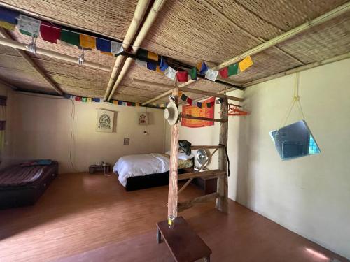 a room with a bed and flags hanging from a ceiling at Organic Retreats in Pokhara