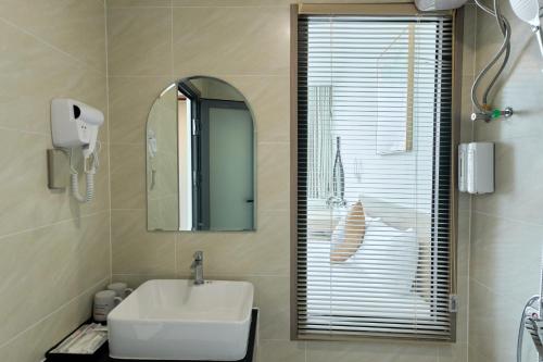 a bathroom with a sink and a mirror at Cherry Airport Hotel and Apartment 2 in Ho Chi Minh City