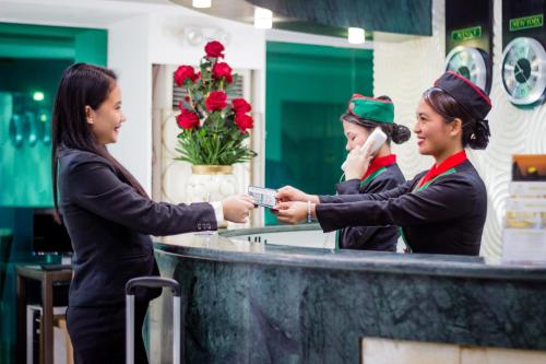 three women are standing at a counter in a restaurant at Eurotel Boracay in Boracay