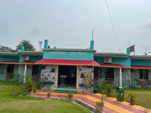 a building with a sign that reads embassy six legs at Panthanibas momochitte in Bakkhali