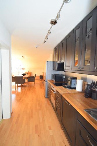 a kitchen with wooden counter tops and a dining room at Hotel Unterhof in Filzmoos