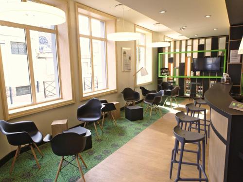 a waiting room with a bunch of stools at ibis Styles Moulins Centre in Moulins