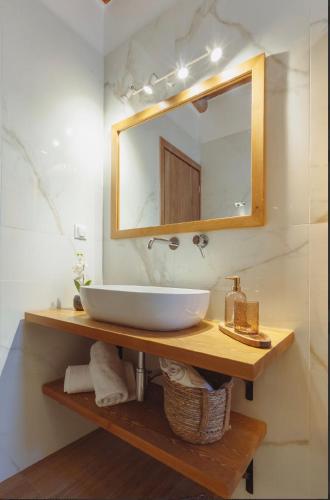 a bathroom with a white sink and a mirror at Morning glow villa in Antiparos