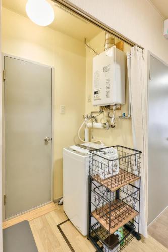 a laundry room with a sink and a washing machine at Bird Heights 101 in Furano