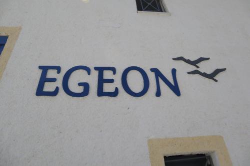a sign on the side of a building with two planes at Egeon Studios in Neos Marmaras
