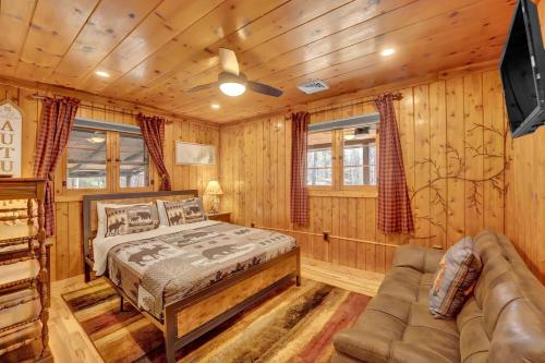 a log cabin bedroom with a bed and a couch at Beartop Lodge Cozy Rustic Cabin Fire Pit in Blakeslee