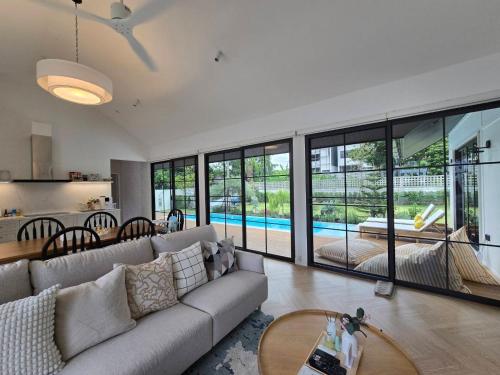 a living room with a couch and a table at DRIZZLE pool and pillows in Phra Khanong