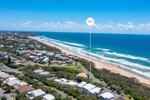 an aerial view of a beach with a speed limit sign at Sophisticated & stylish beachside apartment with pool in Sunrise Beach