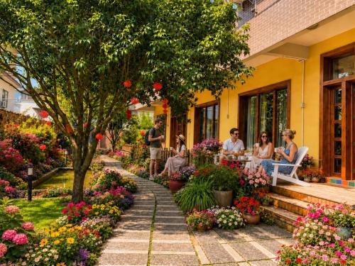a group of people sitting outside of a flower shop at Yangshuo Eden's Social Guesthouse - cozy garden courtyard & fresh craft coffee & night beers & outdoor activities in Yangshuo
