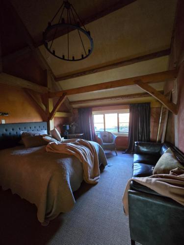 a bedroom with two beds and a couch at housewithnonails in Matamata