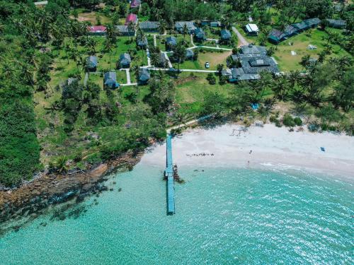 an aerial view of a beach with houses and the ocean at S Beach Resort in Ko Kood