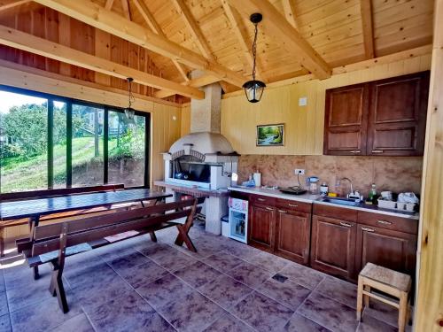 a kitchen with a bench in the middle of it at Planinski Mir in Zaovine