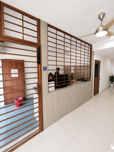 a room with a door and a person in the mirror at Sun Inns Skudai in Skudai
