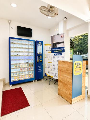 a room with a ticket machine and a large display at Sun Inns Skudai in Skudai