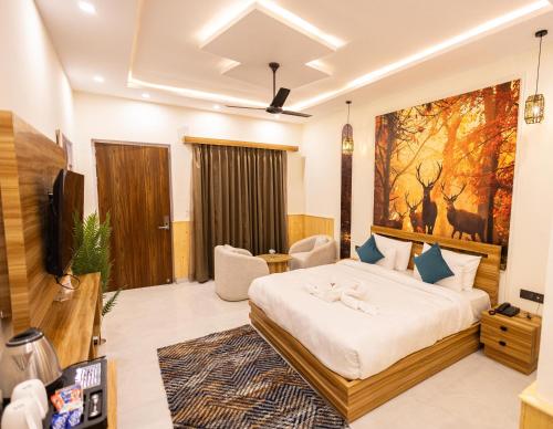 a hotel room with a bed and a tv at Tiger Aura Resort in Rāmnagar