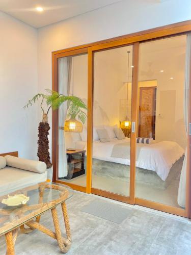 a living room with a bed and a table at 2BR Private Pool Beach Villa Near Sanur & Ubud in Ketewel
