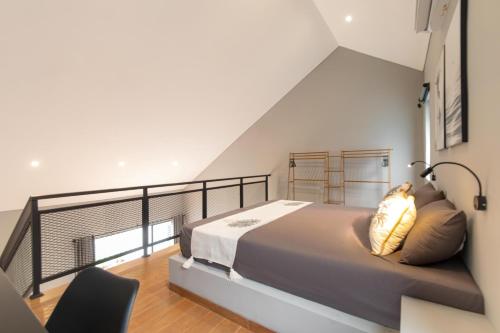 a bedroom with a bed and a balcony at Iris Apartment in Dalung