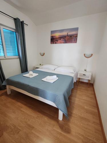 a bedroom with a bed with two towels on it at Holiday home Tcono in Tkon