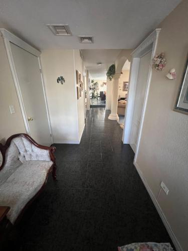 a hallway of a home with a couch and a hallway at House in a private gated community in Chihuahua